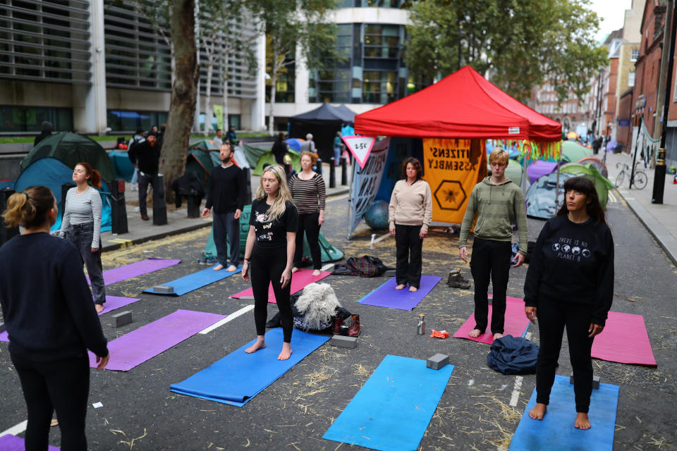 Early morning yoga at the Extinction Rebellion camp in Marsham Street, Westminster, London.