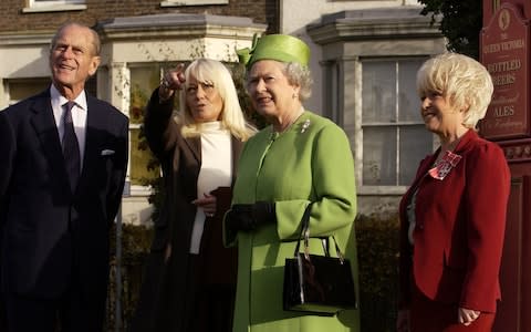 The Queen and Duke of Edinburgh being given a tour of the EastEnders set in 2011 by Wendy Richards and Barbara Windsor - Credit: Fiona Hanson/PA