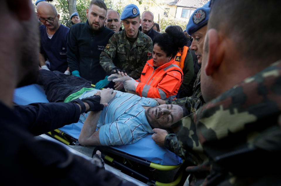 Military and emergency personnel helps an injured man in Thumane, after an earthquake shook Albania, November 26, 2019. (Photo: Florion Goga/Reuters)