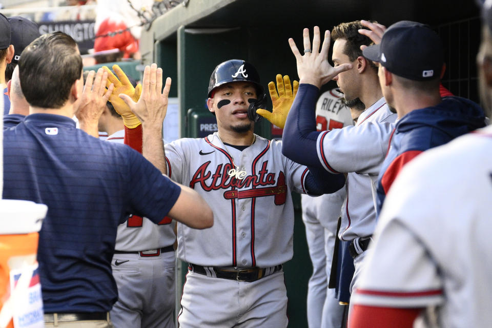 Atlanta Braves' William Contreras, center, celebrates in the dugout after he scored on a single by Michael Harris II during the fourth inning of a baseball game against the Washington Nationals, Wednesday, June 15, 2022, in Washington. (AP Photo/Nick Wass)