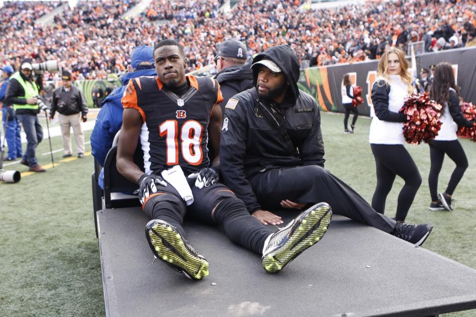 The last thing Andy Dalton (and all Bengals fans) wants to see: A.J. Green on a medical cart. (AP)