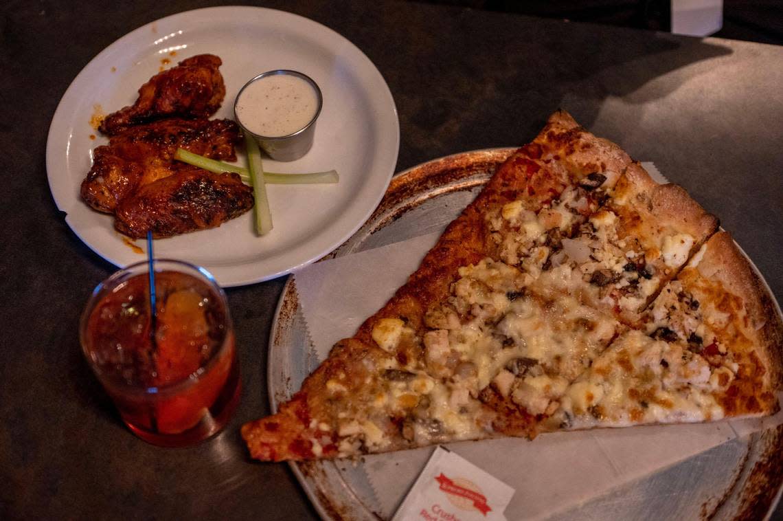 J.M. Banks’ regular order at The Combine: house-made Buffalo wings, an old-fashioned cocktail and a Custom Slice with chicken, cream cheese, mushrooms, onions and roasted garlic.