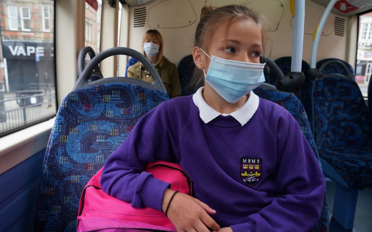 All children aged five and over are to have to wear a face mask on school buses in Scotland - PA