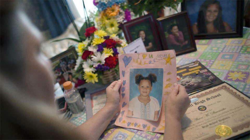 Shuemake holds a picture of her daughter during an interview at her home in Middletown Photo: AP/John Minchillo