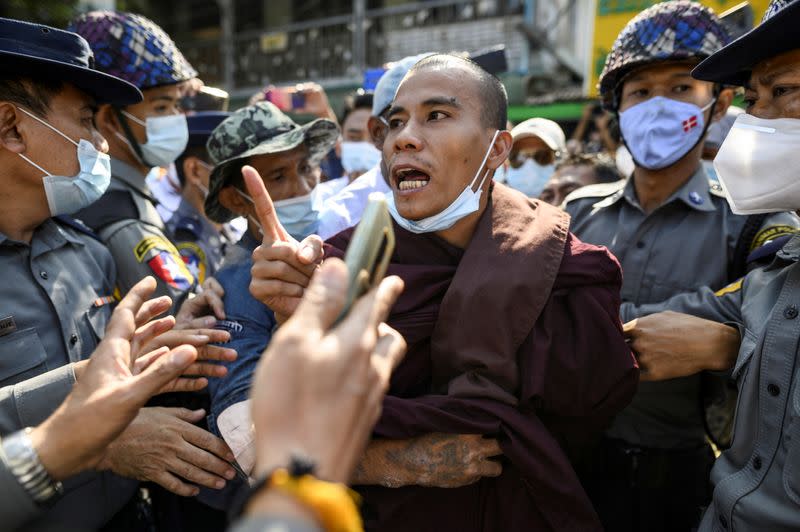 Police detain a Buddhist monk while he takes part in a protest in support of the jailed nationalist right wing monk Wirathu outside Insein prison in Yangon