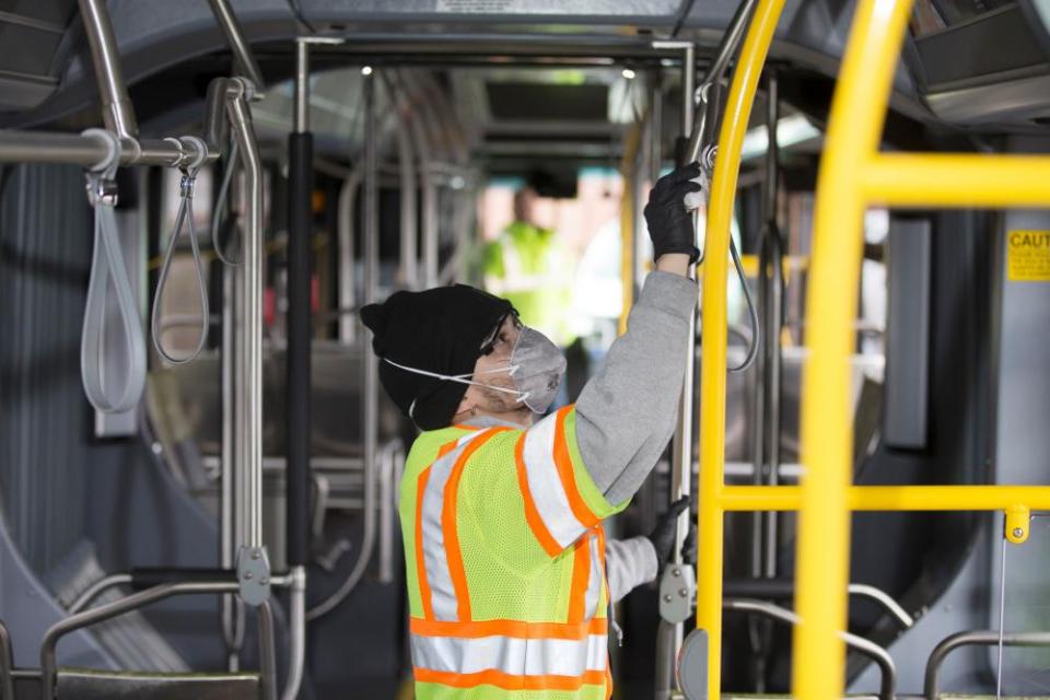 A worker cleans a bus in response to the Seattle-area novel coronavirus outbreak in Seattle.