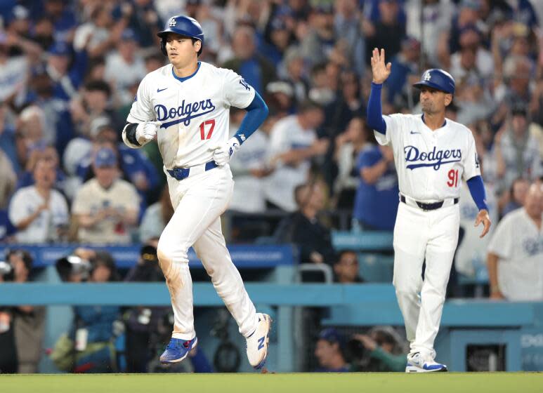 The Dodgers' Shohei Ohtani rounds the bases after hitting a two-run home run against the Rangers