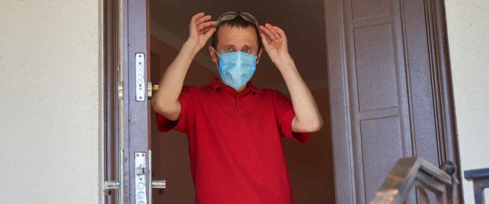 guy goes for a walk in a medical mask,young man leaves home in medical mask