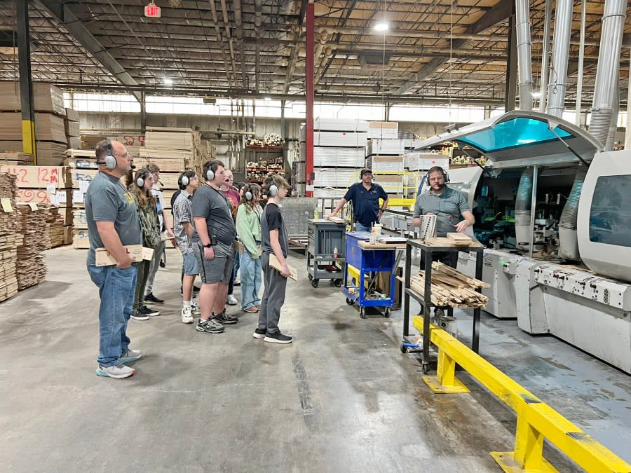 Kyle Evans, vice president of manufacturing at Mullican Flooring, explains the operation of one of the many pieces of machinery the company uses in its manufacturing processes