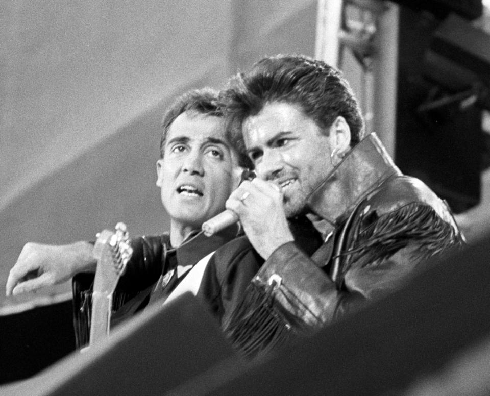 Pop duo Wham partners, Andrew Ridgeley (l) and George Michael, on stage at Wembley Stadium for their sell-out farewell concert.