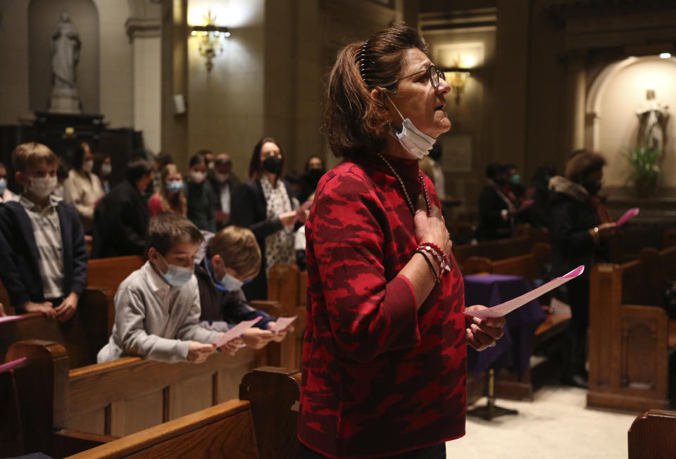 Parishioners sing along with the French choir, Chorale Sainte Marie Reine, during a French Mass at the Church of Notre Dame in New York, on Sunday, March 6, 2022. (AP Photo/Jessie Wardarski)