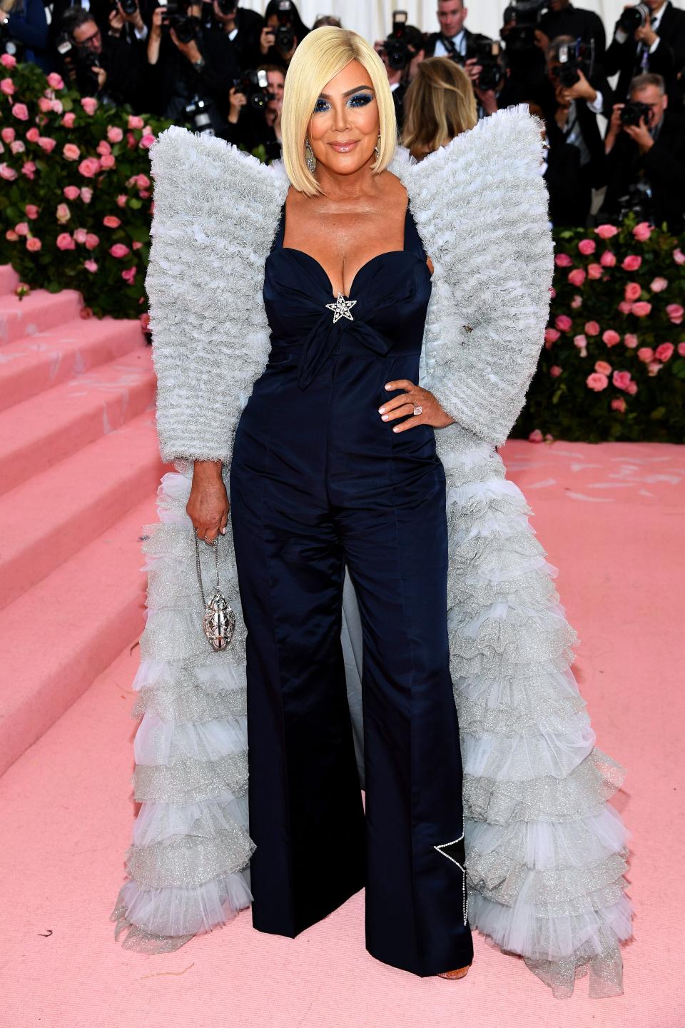 Kris Jenner stunned everyone at an event when she appeared in a dark-blue color jumpsuit with a fury and shiny jacket.