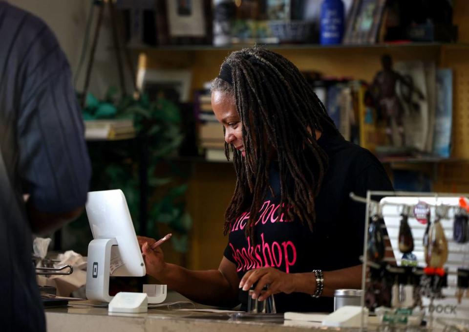 Donna Craddock checks out a customer The Dock Bookshop on Friday, May 3, 2024, in Fort Worth. Craddock and her sister, Donya, opened the store in 2008 to provide a place focused on Black literature for the community.