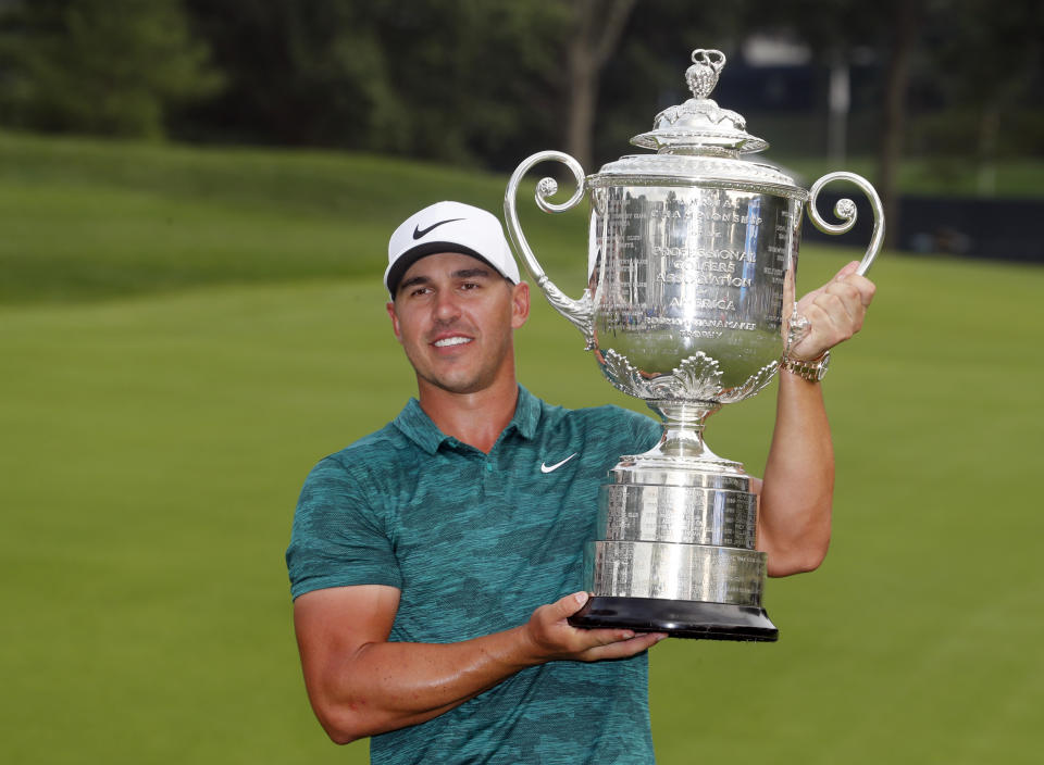 FILE - In this Sunday, Aug. 12, 2018, file photo, Brooks Koepka poses with the Wanamaker Trophy after winning the PGA Championship golf tournament at Bellerive Country Club, in St. Louis. Koepka defends his title on May 16, 2019, at Bethpage Black. (AP Photo/Jeff Roberson, File)