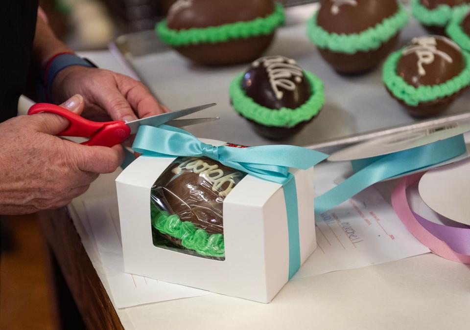 An employee packages a custom hollow chocolate egg at Nandy's Candy in Jackson on Tuesday. Emmie King, owner, said the custom eggs are very popular Easter items.