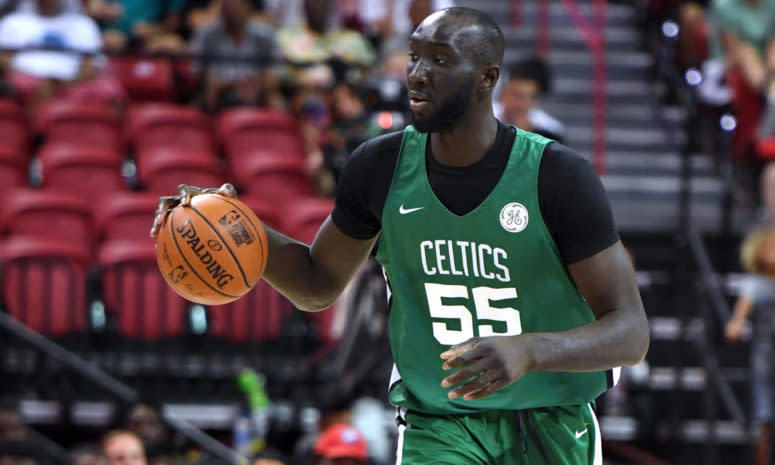 Boston Celtics center Tacko Fall takes the ball up the floor.