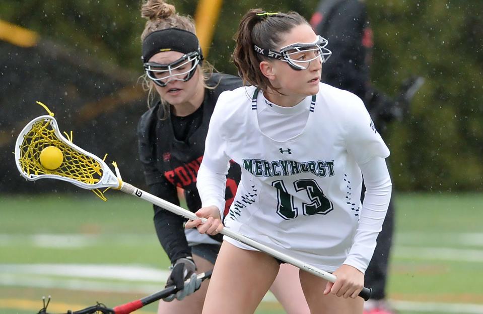 Mercyhurst University freshman Hannah Young, right, competes against Edinboro University during a women's lacrosse game in Erie on April 3. Young scored twice in the Lakers' 15-8 win. The Lakers will compete as an NCAA Division I team next season.
