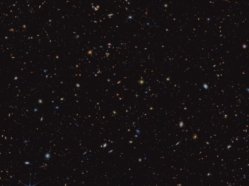 James Webb Space Telescope image showing 45,000 galaxies as small splashes of light against the black void of deep space.