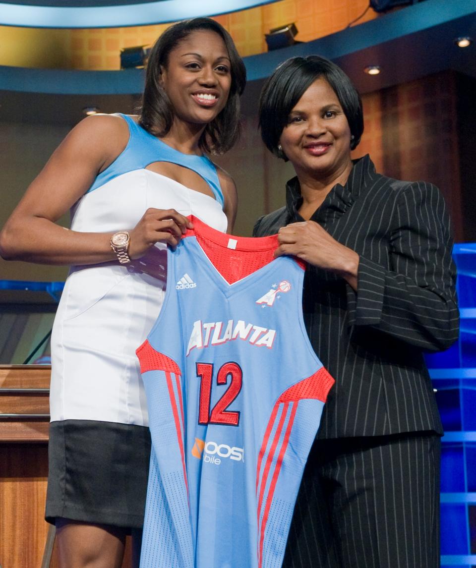 Connecticut's Tiffany Hayes left, holds up an Atlanta Dream jersey with Renee Brown, Chief of Basketball Operations and Player Relations, after the Dream selected Hayes as the No. 14 pick in the WNBA basketball draft in Bristol, Conn., Monday, April 16, 2012. (AP Photo/Jessica Hill)