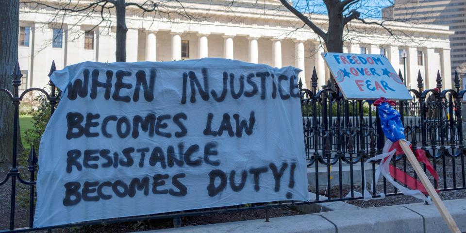 Signs hang near the Capitol building against the state's extended stay at home order to help slow the spread of the coronavirus disease (COVID 19), in Columbus, Ohio, on April 20, 2020..JPG