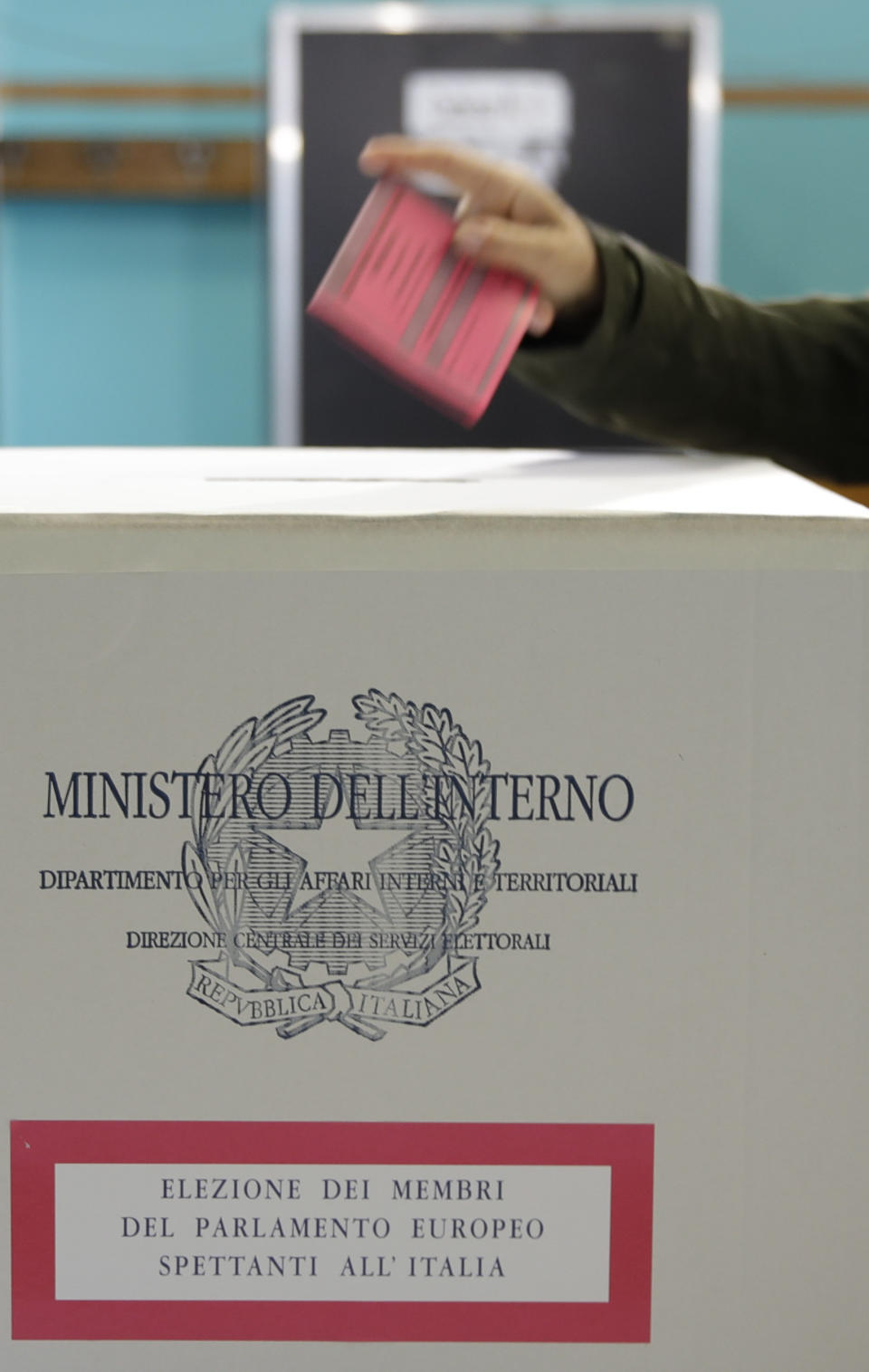 A voter casts the ballot at a polling station in Rome, Sunday, May 26, 2019. Pivotal elections for the European Union parliament reach their climax Sunday as the last 21 nations go to the polls and results are announced in a vote that boils down to a continent-wide battle between euroskeptic populists and proponents of closer EU unity. (AP Photo/Alessandra Tarantino)