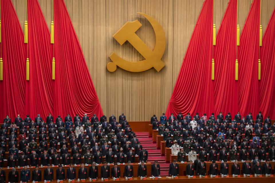 Delegates stand for a moment of silence during the opening ceremony of the 20th National Congress of China's ruling Communist Party at the Great Hall of the People in Beijing, China, Sunday, Oct. 16, 2022. The overarching theme emerging from China's ongoing Communist Party congress is one of continuity, not change. The weeklong meeting is expected to reappoint Xi Jinping as leader, reaffirm a commitment to his policies for the next five years and possibly elevate his status even further as one of the most powerful leaders in China's modern history. (AP Photo/Mark Schiefelbein)