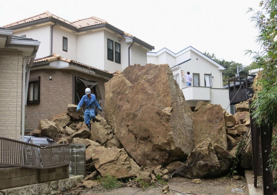 Rocks are seen in a residential area following a landslide caused by Typhoon Wipha in Kamakura, south of Tokyo, in this photo taken by Kyodo October 16, 2013. Eight people were killed and over 30 missing, with nearly 20,000 people ordered to evacuate and hundreds of flights cancelled as Typhoon Wipha pummelled the Tokyo region on Wednesday, leaving piles of wreckage on one small island but largely sparing the capital. (REUTERS/Kyodo)