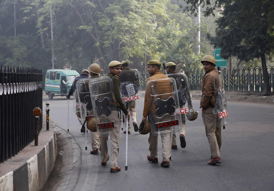 Police patrol a street in Lucknow, Uttar Pradesh state, India, Sunday, Dec. 22, 2019. Violent protests against India's citizenship law that excludes Muslim immigrants have swept the country over the weekend despite the government's ban on public assembly and suspension of internet services in many parts. Police said nine people died in clashes with security forces in Uttar Pradesh on Saturday, most of them young protesters. (AP Photo/Rajesh Kumar Singh)