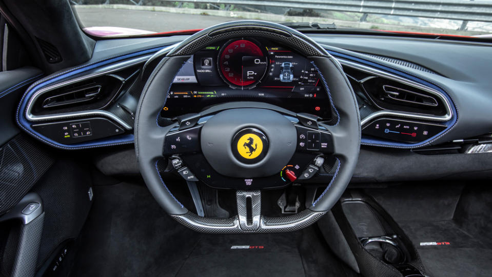 The steering wheel and dashboard of a Ferrari 296 GTS. 