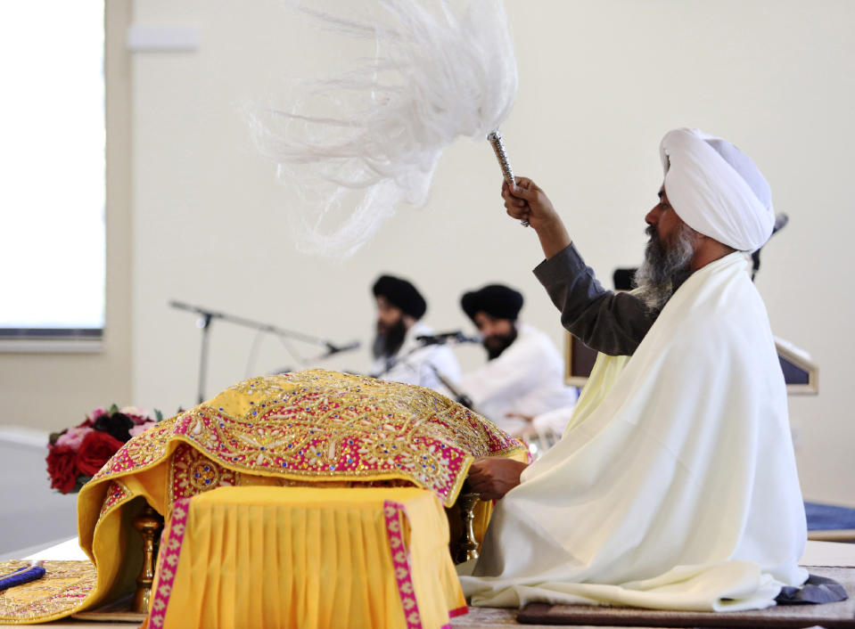 In this April 12, 2020 photo, Giani Baljinder Singh Ji leads a Sehaj Paath service for congregants watching via a livestream at Guru Nanak Mission in Oakland, N.J. Guru Nanak Mission has begun livestreaming all services due to New Jersey's order to stay at home during the coronavirus pandemic. (AP Photo/Jessie Wardarski)