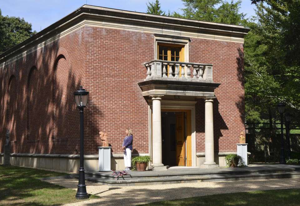 A visitor looks at Garden Nymphs outside the Renaissance-styled Palladian museum that houses The Leiber Collection Friday, Sept. 17, 2022, in the hamlet of The Springs, in East Hampton, N.Y. The Leiber Collection Sculpture Garden is filled with art, some by Gerson, and also features exhibitions. (AP Photo/Pamela Hassell)