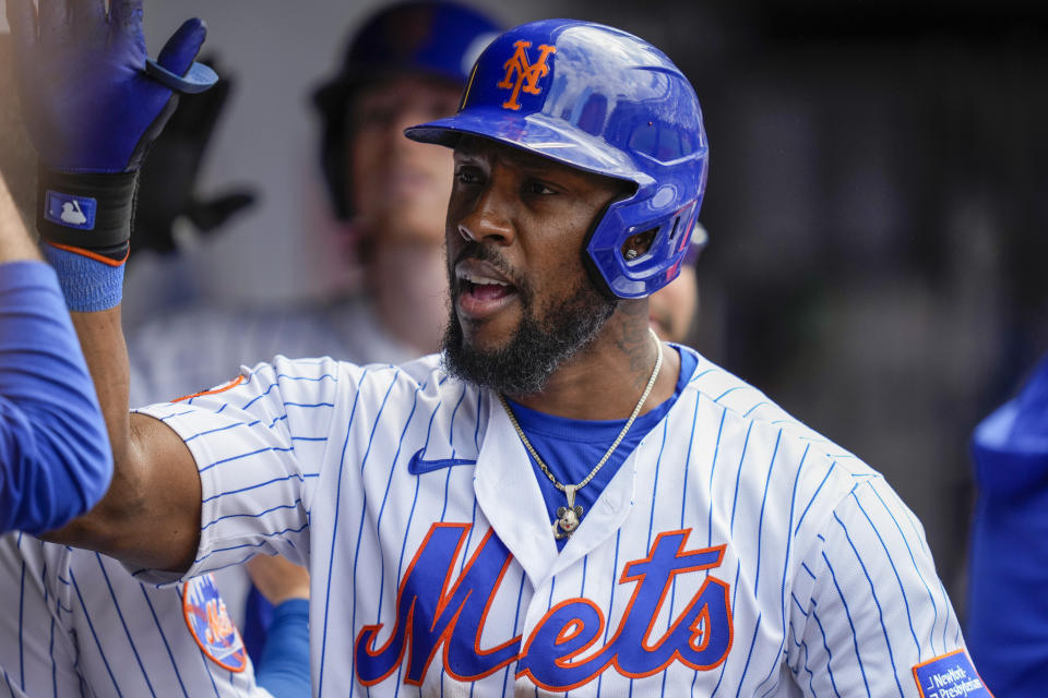 New York Mets' Starling Marte (6) celebrates in the dugout after hitting the go-ahead two-run home run off Cleveland Guardians relief pitcher Trevor Stephan (37) in the eighth inning of the opener of a split doubleheader baseball game, Sunday, May 21, 2023, in New York. (AP Photo/John Minchillo)