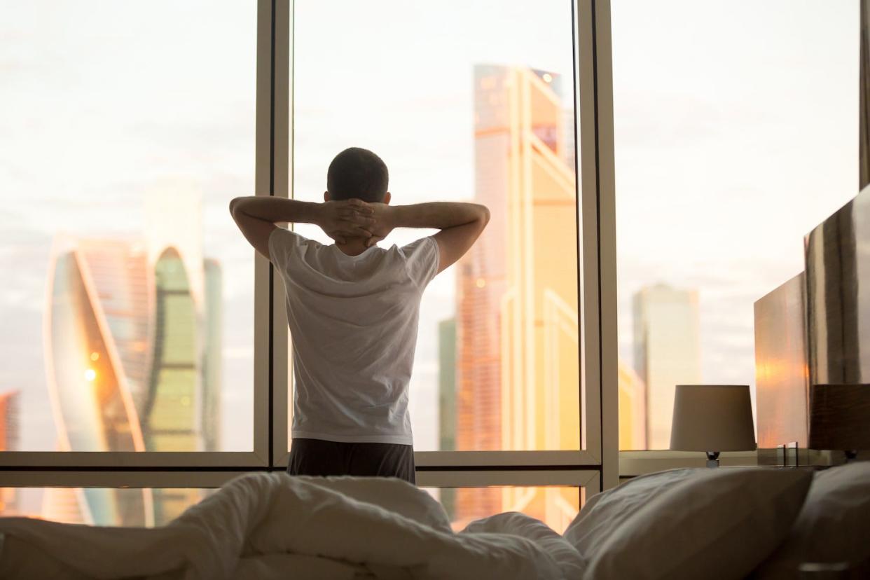 Man Waking Up Looking Out Window