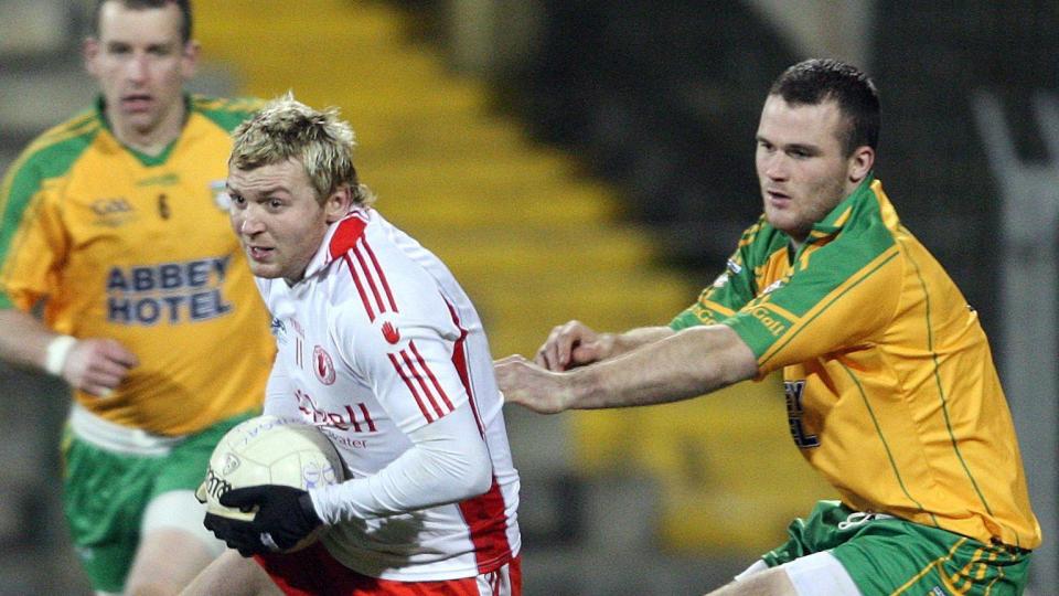 Owen Mulligan attempts to burst away from Donegal's Neil McGee during an Allianz Football League Division One game in 2009