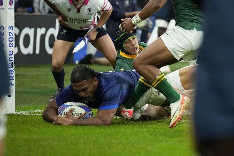 France's Peato Mauvaka goes over the line to score a try during the Rugby World Cup quarterfinal match between France and South Africa at the Stade de France in Saint-Denis, near Paris Sunday, Oct. 15, 2023. (AP Photo/Christophe Ena)