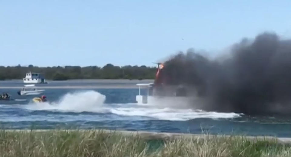 Jet-skiers have fought a houseboat fire on the Gold Coast. Source: 7 News