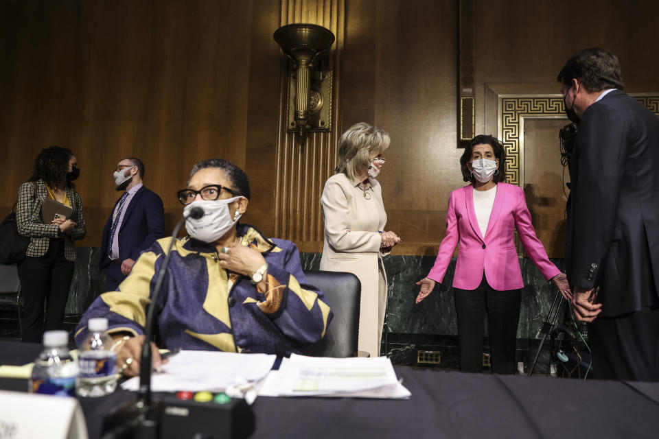 Commerce Secretary Gina Raimondo, second right, speaks with, Sen. Cindy Hyde-Smith, R-Miss., and Sen. Bill Hagerty, R-Tenn., right, as Housing and Urban Development Secretary Marcia Fudge, left, arrives for a Senate Appropriations Committee hearing on Capitol Hill, Tuesday, April 20, 2021 in Washington. (Oliver Contreras/The Washington Post via AP, Pool)