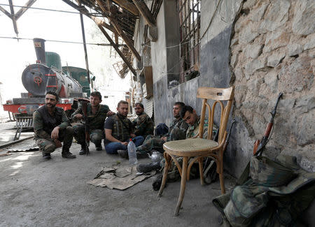 Soldiers loyal to Syria's President Bashar al-Assad forces are seen at al-Qadam train station near Yarmouk Palestinian camp in Damascus, Syria April 29, 2018. REUTERS/Omar Sanadiki