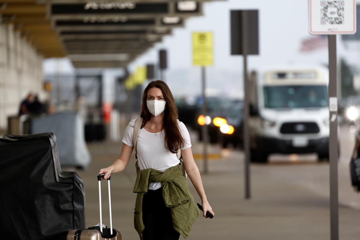 A traveler walks through terminals at Ronald Reagan Washington National Airport in Arlington, Virginia, April 14, 2022. (Photo by Ting Shen/Xinhua via Getty Images)