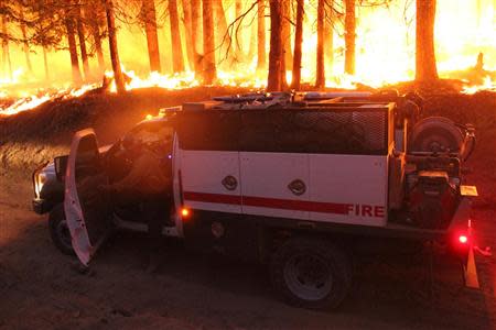 A firefighter and his pump rig stops at the Rim Fire at night in this undated United States Forest Service handout photo near Yosemite National Park, California, released to Reuters August 30, 2013. REUTERS/Mike McMillan/U.S. Forest Service/Handout via Reuters