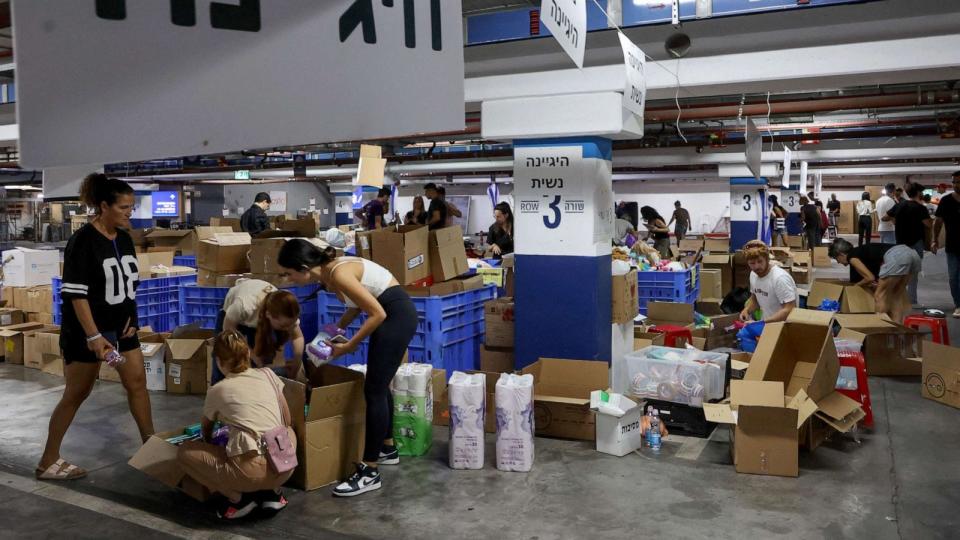 PHOTO: Volunteers prepare aid packages and supplies for Israeli soldiers and evacuated residents in Tel Aviv on October 12, 2023. (Gil Cohen-magen/AFP via Getty Images)