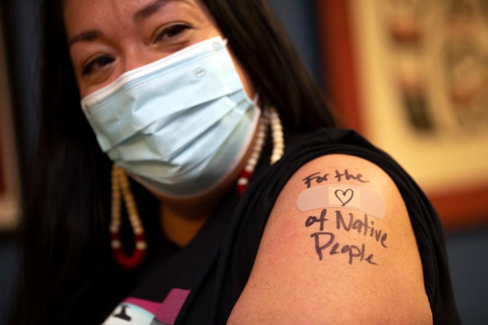 Abigail Echo-Hawk, Chief Research Officer with Seattle Indian Health Board (SIHB) and a member of the Pawnee Tribe, shows off her arm after she received a shot of the Moderna COVID-19 vaccine, at the SIHB, on Dec. 21, 2020 in Seattle, Wash. A colleague used a black pen to inscribe, For the (Heart) love of Native People over the spot where she got the injection. 