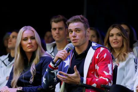 Olympian freestyle skier Gus Kenworthy speaks next to skier Lindsey Vonn during an event in Times Square to celebrate 100 days from the start of the PyeongChang 2018 Olympic Games in South Korea, in New York, U.S., November 1, 2017. REUTERS/Lucas Jackson