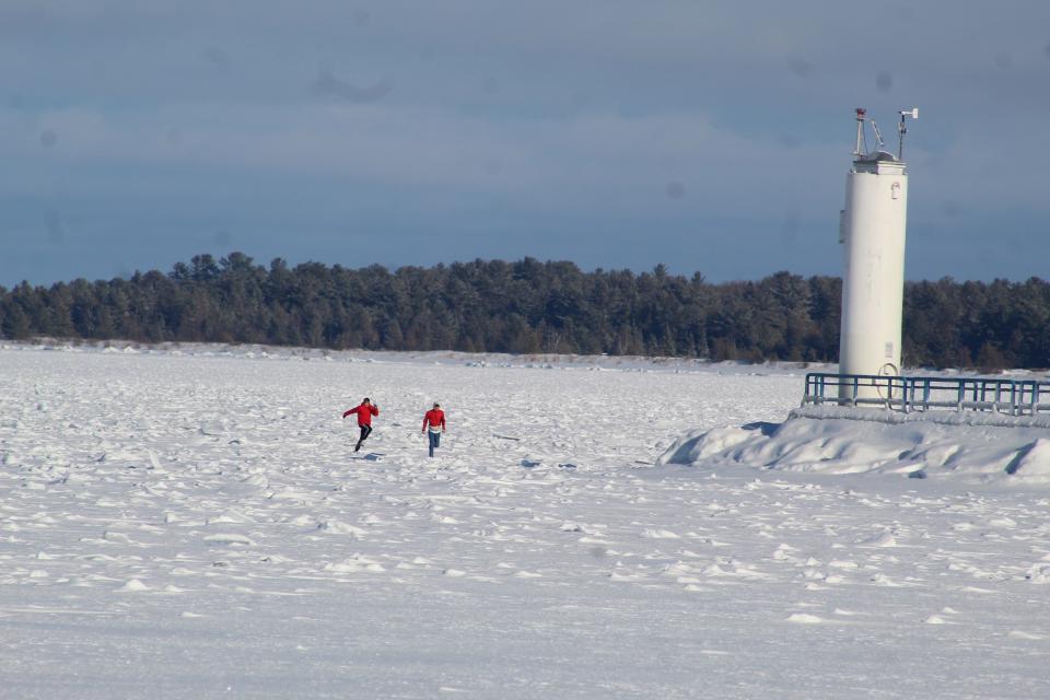 People enjoyed the warmer sunny weather on Sunday, Jan. 30 near the Crib Lighthouse in Cheboygan on Lake Huron.