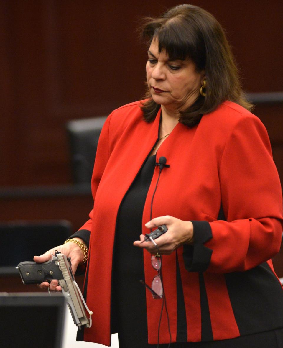 State Attorney Angela Corey shows the 9mm handgun used by Michael Dunn to kill Jordan Davis as part of the trial proceedings in Jacksonville, Fla. Monday, Feb. 10, 2014. The prosecution has rested in the trial of Dunn who is charged with killing Davis following an argument over loud music outside a Jacksonville convenience store in 2012. (AP Photo/The Florida Times-Union, Bob Mack, Pool)