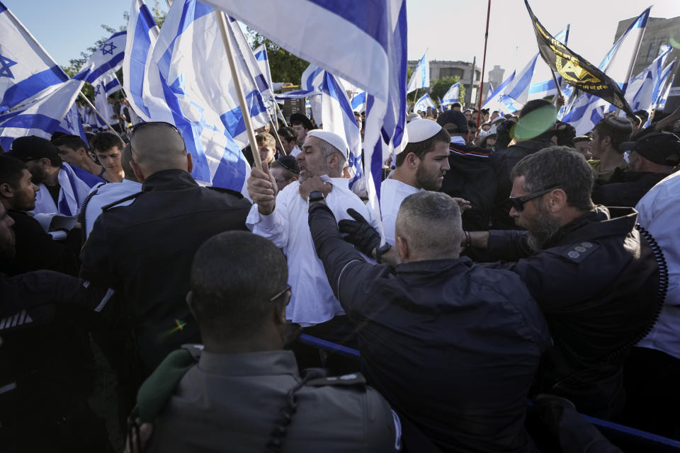 Israeli police block right wing activists from marching towards the Old City, in Jerusalem, Wednesday, April 20, 2022. Police prevented hundreds of ultra-nationalist Israelis from marching around predominantly Palestinian areas of Jerusalem's Old City. The event planned for Wednesday was similar to one that served as one of the triggers of last year's Israel-Gaza war. (AP Photo/Ariel Schalit)