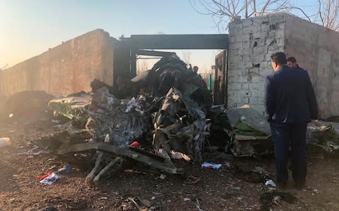 Debris is seen from a plane crash on the outskirts of Tehran - Credit: Mohammad Nasiri/AP