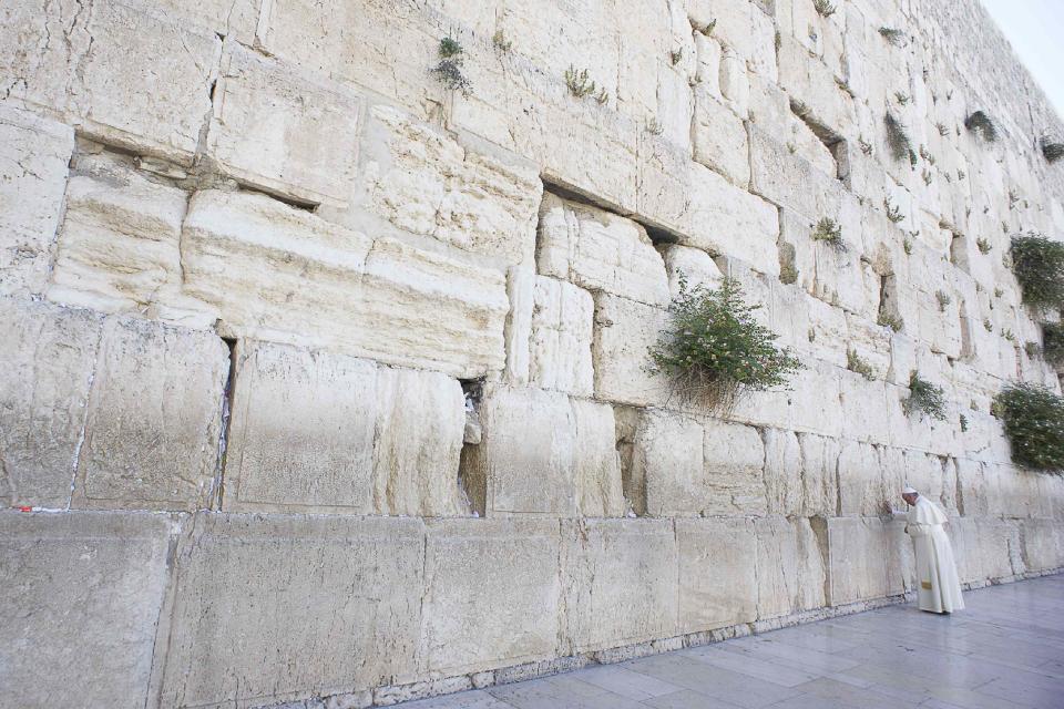 Pope Francis touches the stones of the Western Wall, Judaism's holiest prayer site, in Jerusalem's Old City