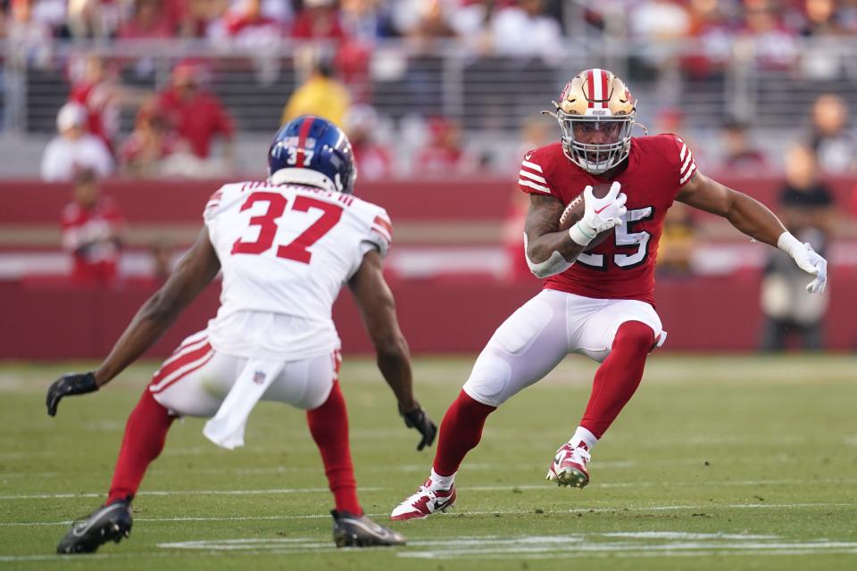 Sep 21, 2023; Santa Clara, California, USA; San Francisco 49ers running back Elijah Mitchell (25) runs the ball next to New York Giants cornerback Tre Hawkins III (37) in the second quarter at Levi's Stadium. Mandatory Credit: Cary Edmondson-USA TODAY Sports