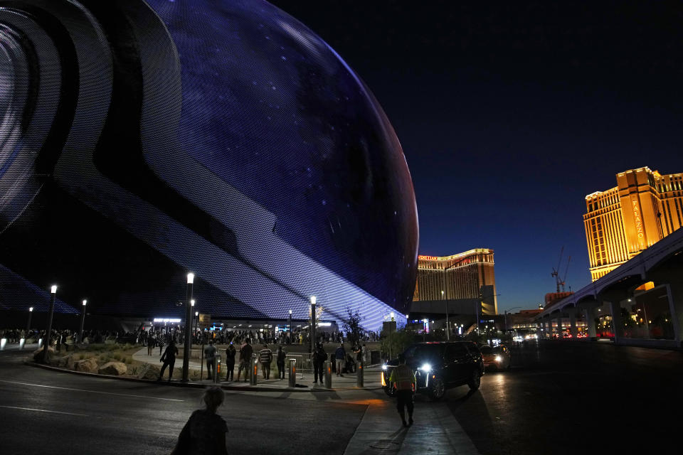FILE - People arrive during the opening night of the Sphere, Sept. 29, 2023, in Las Vegas. A man who scaled the exterior of the massive Sphere venue in Las Vegas on Wednesday morning, Feb. 7, 2024, was taken into custody, authorities said. (AP Photo/John Locher, File)